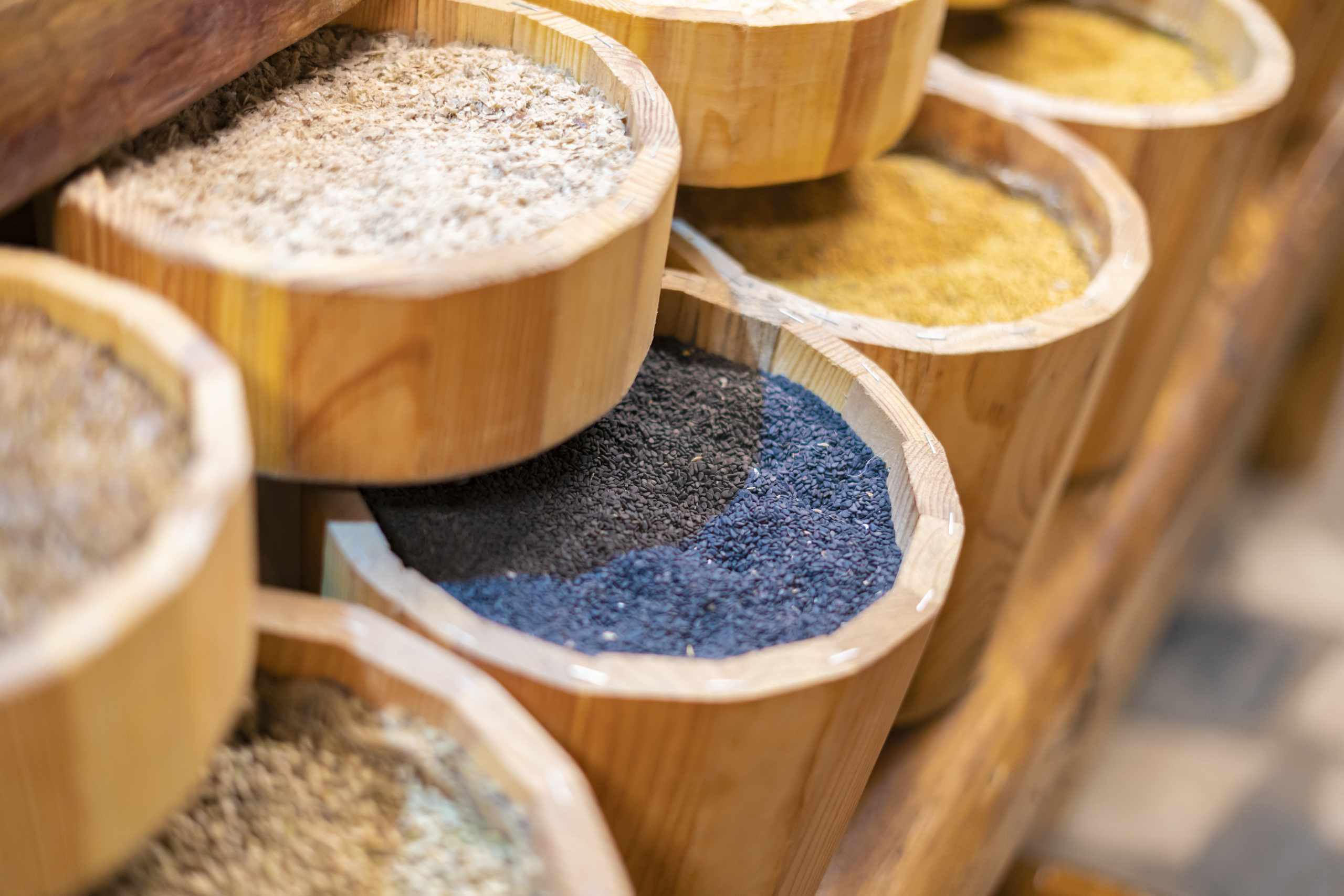 Rows of natural grains and pigments on a market counter